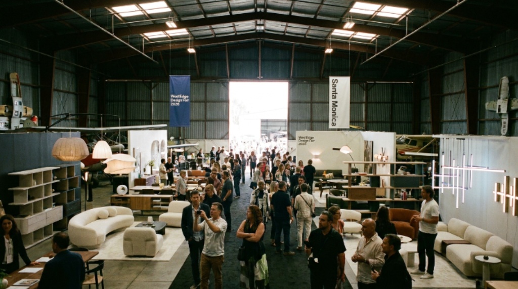 Visitors browsing contemporary furniture and lighting displays inside the Barker Hangar during WestEdge Design Fair 2026 in Santa Monica, California